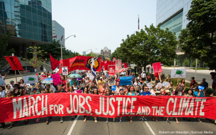 Thousands march through downtown Toronto during the Jobs, Justice & the Climate March on July 5th, 2015. The march was led by First Nations followed by frontline, impacted communities from across Toronto and beyond. The people were marching to call for action on climate change.